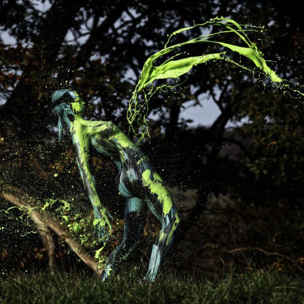Für das Outdoor-Projekt SPLASH ART hat Künstler Jörg Düsterwald ein unbekleidetes Fotomodell mit Körperfarbe bemalt und anschließend in einer Landschaft mit flüssiger Farbe übergossen.