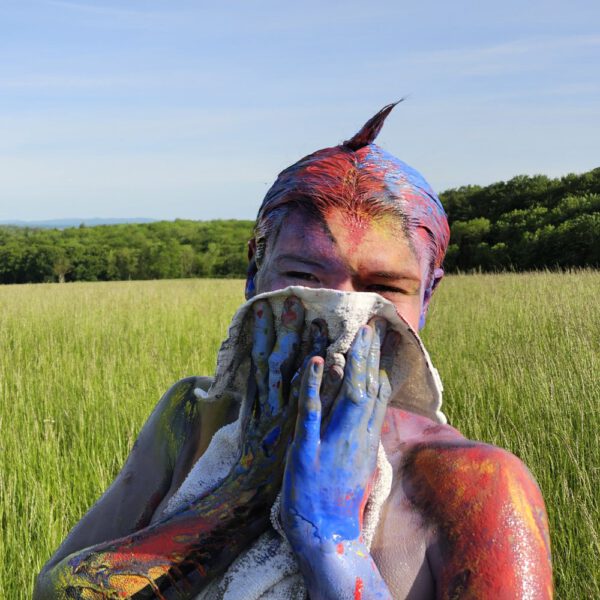 Für das Outdoor-Projekt SPLASH ART hat Künstler Jörg Düsterwald ein unbekleidetes Fotomodell mit Körperfarbe bemalt und anschließend in einer Landschaft mit flüssiger Farbe übergossen.